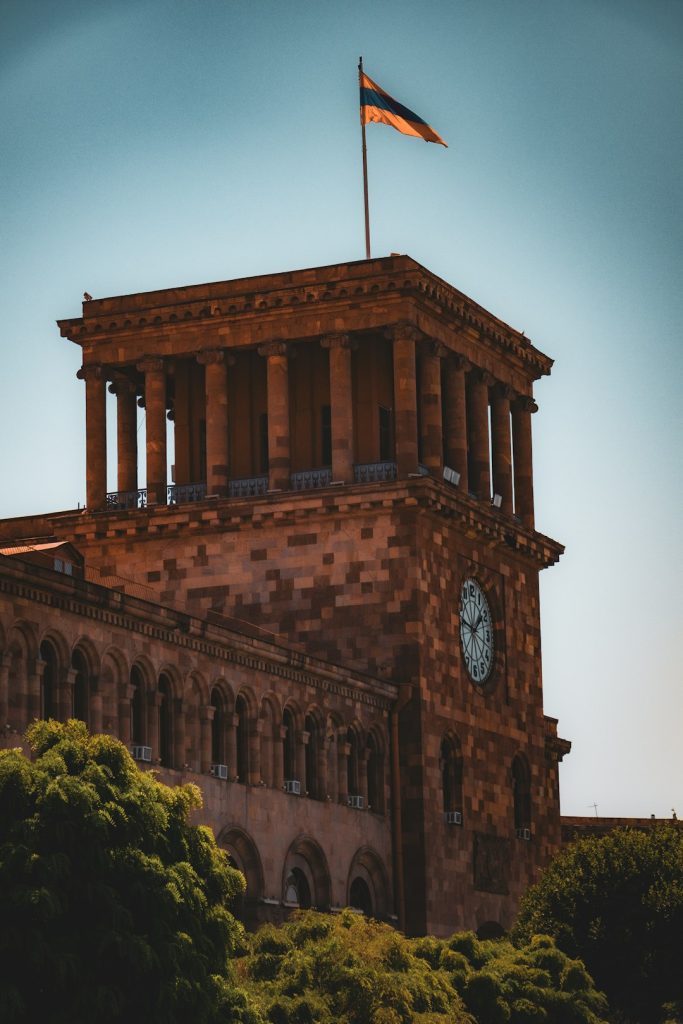 a-tall-building-with-a-clock-on-the-top-of-it-r3z0zqdcqz8